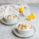 two bowls of the lemon poppy seed baked oatmeal with lemons and the glaze