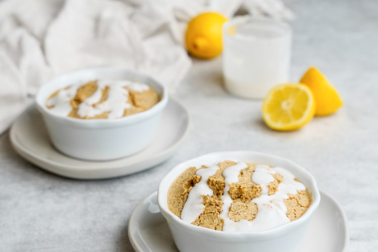 two bowls of the lemon poppy seed baked oatmeal with lemons and the glaze