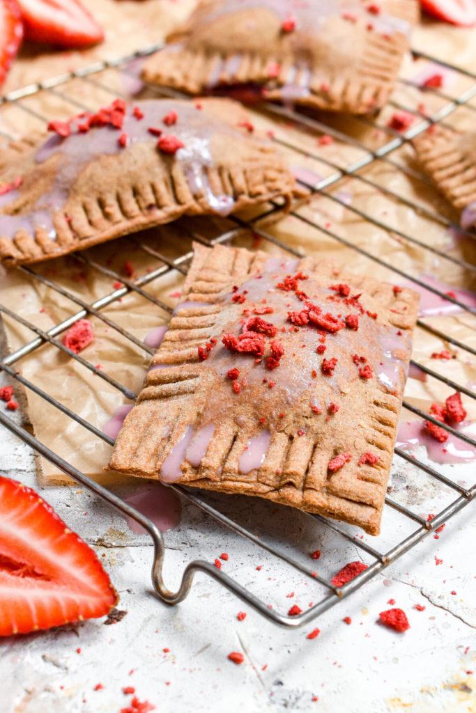 healthy vegan pop tarts on cooling rack with strawberry glaze