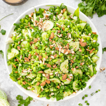 the asian edamame crunch salad with peanut butter dressing next to it