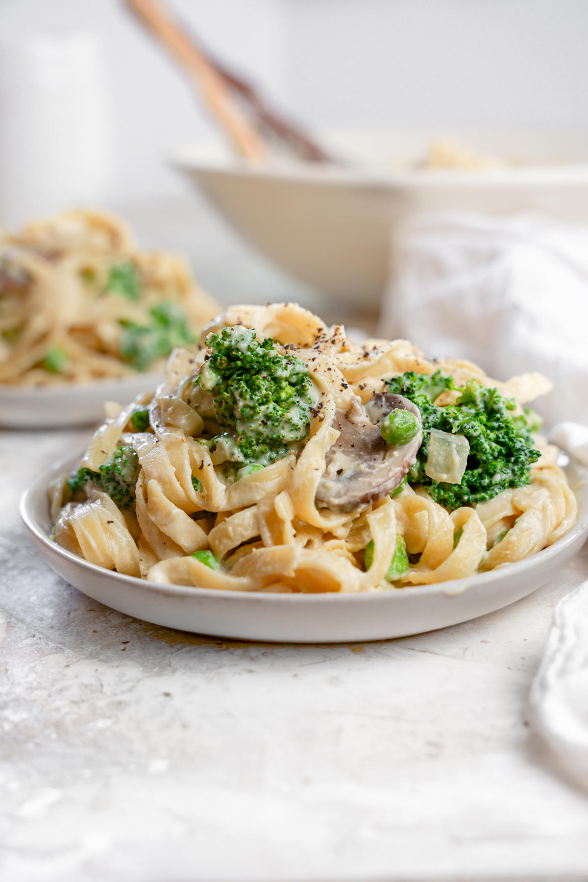 healthy oil-free vegan Alfredo sauce with broccoli, mushrooms, and peas