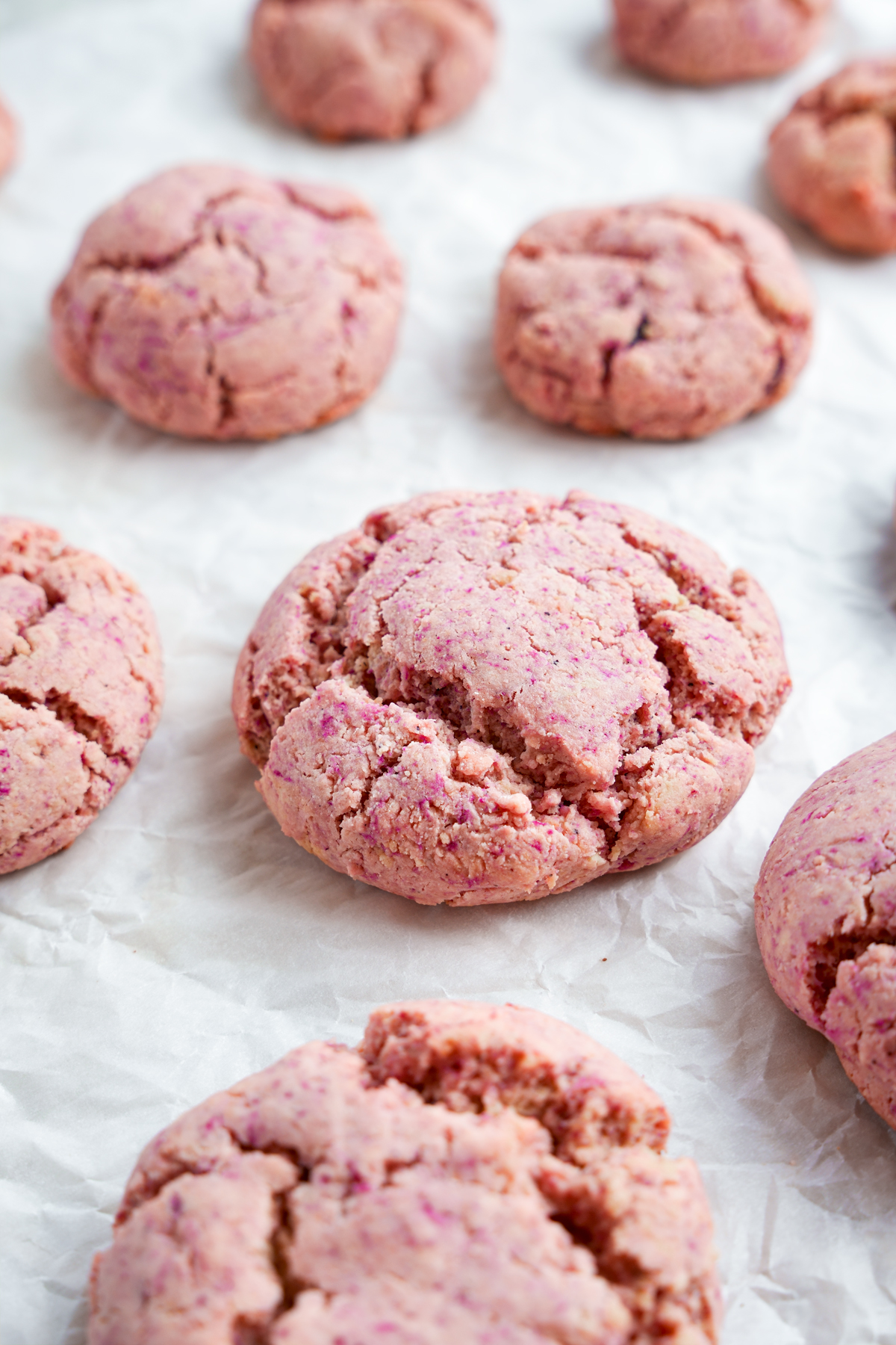 pink lemonade cookies laying on parchment paper