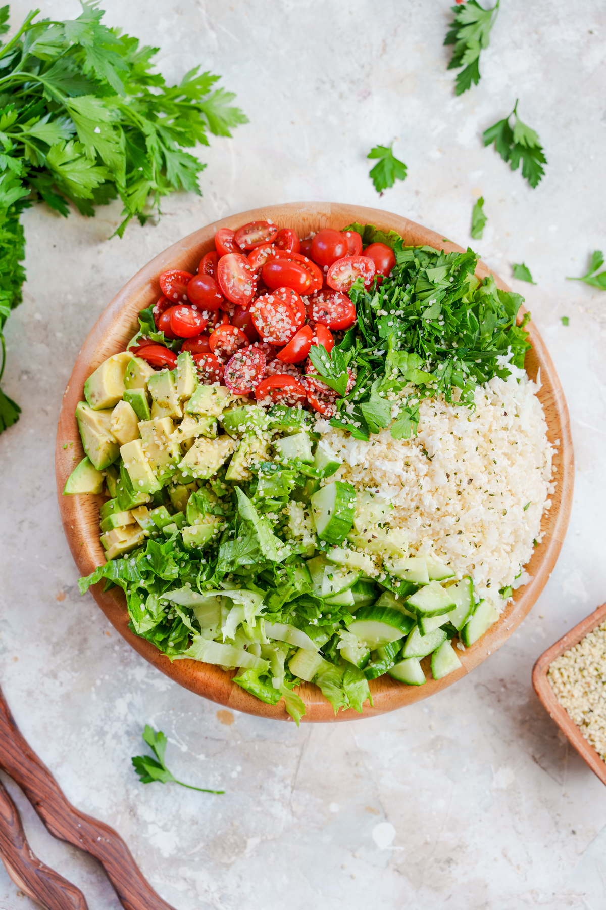  raw vegan tabbouleh with ingredients separated in the bowl to show what's in the recipe 