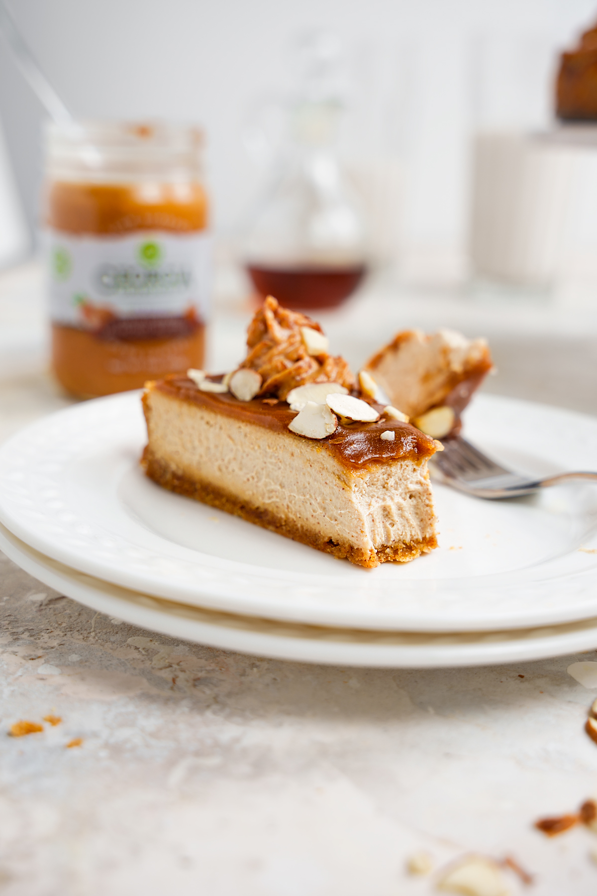 a slice of the refined sugar-free vegan cheesecake with a bite taken out to show the perfect texture.