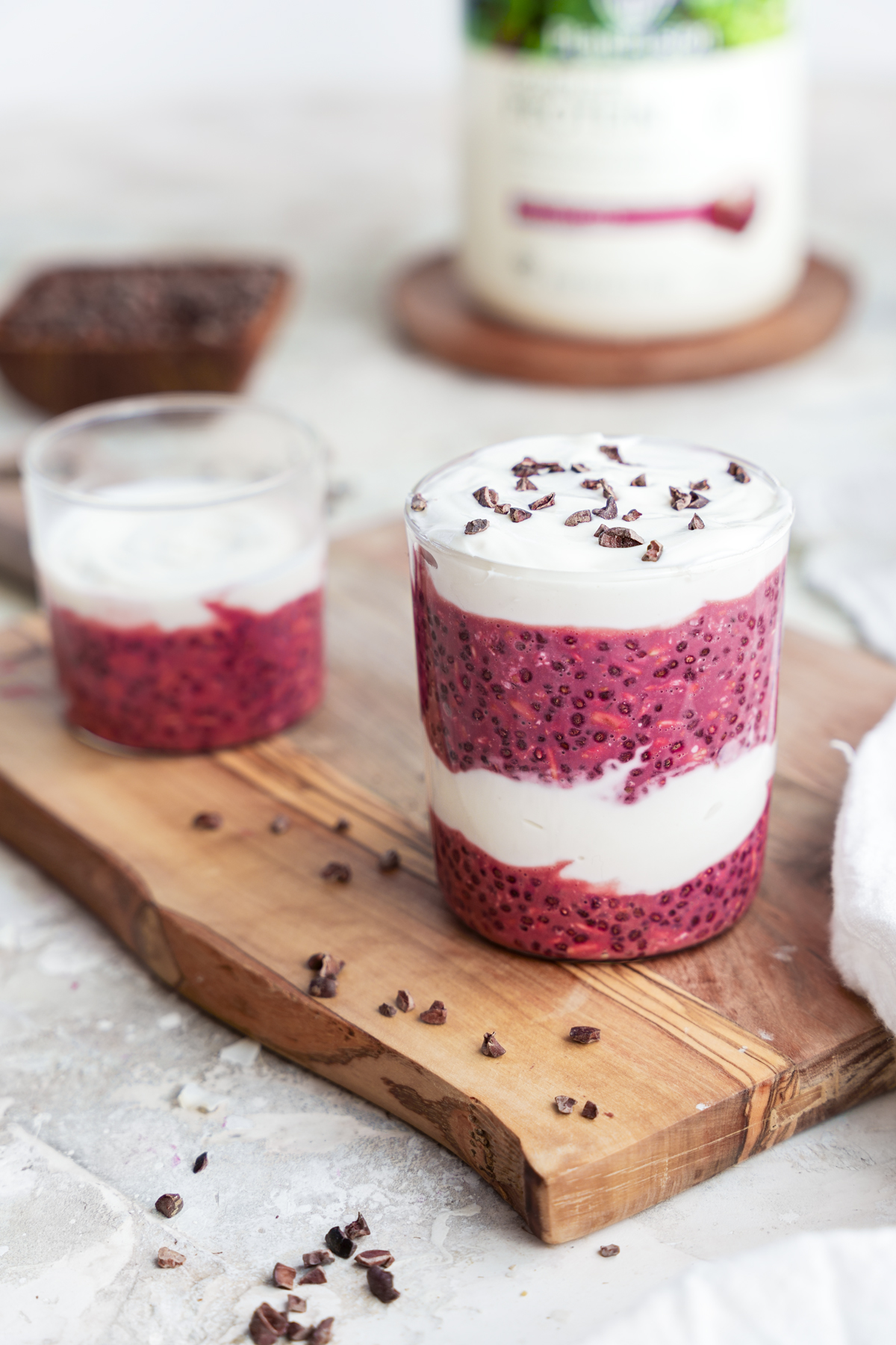 layered red velvet overnight oats with plantfusion red velvet cake protein powder in the background