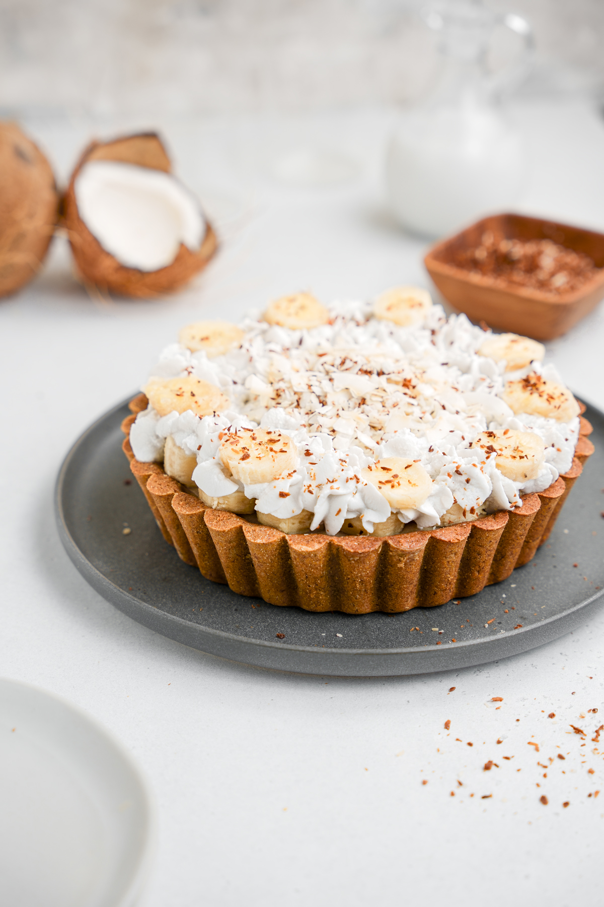 the complete healthy vegan banana cream pie with fresh coconut toppings