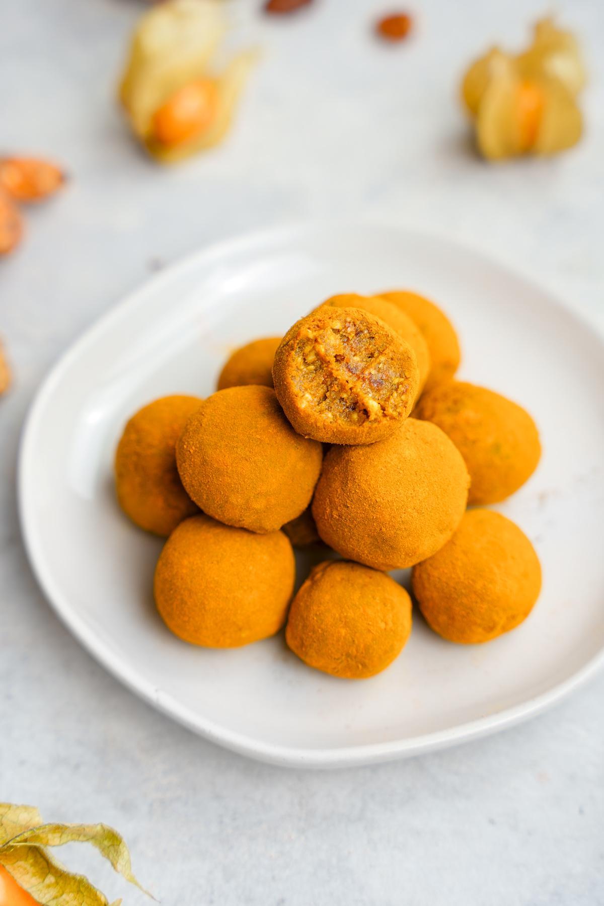 the turmeric bliss balls overtop with a bite taken out of one of them