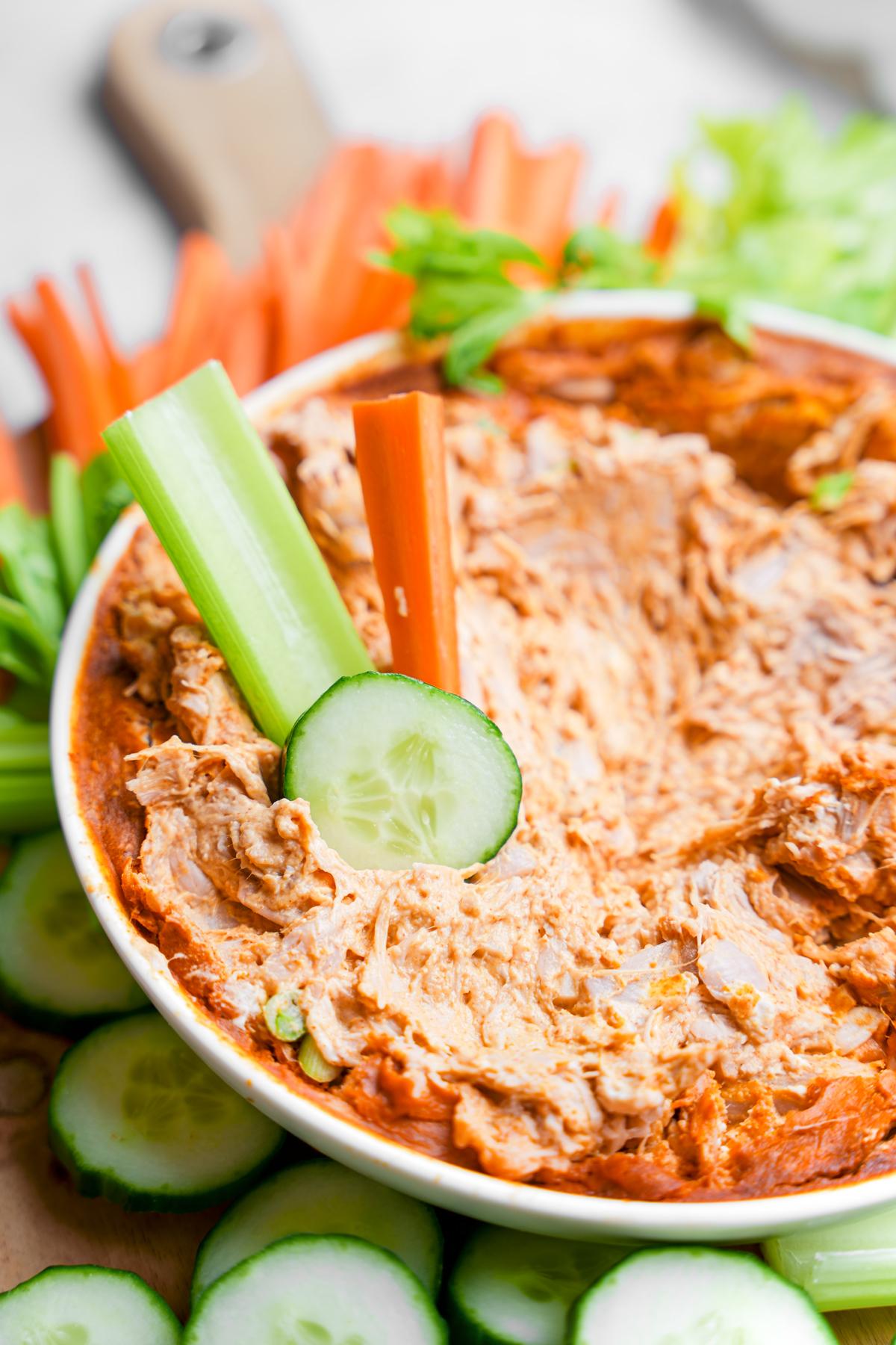 close up of the dip with celery, cucumber, and carrots to show the texture once dipped into 