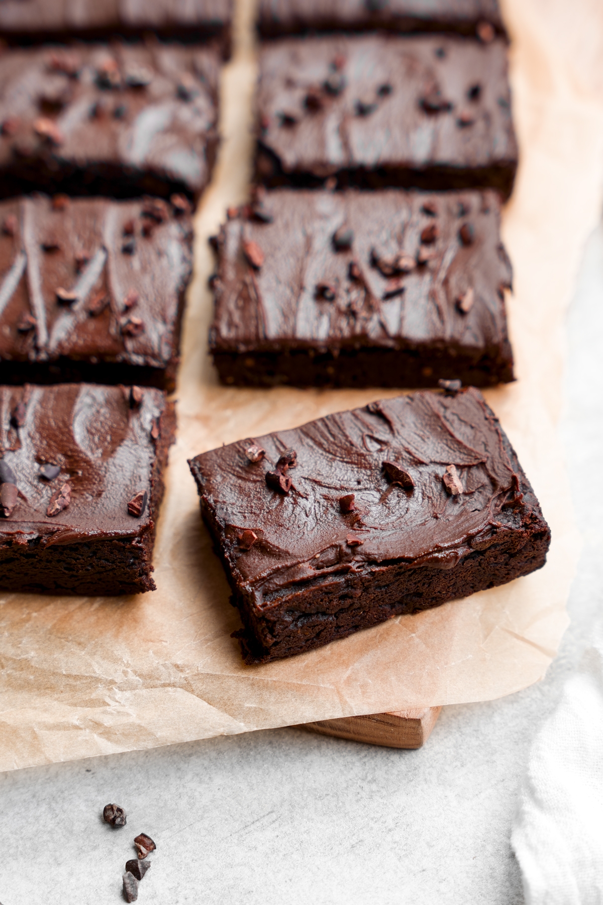 the flourless eggplant brownies lined up with chocolate frosting on top