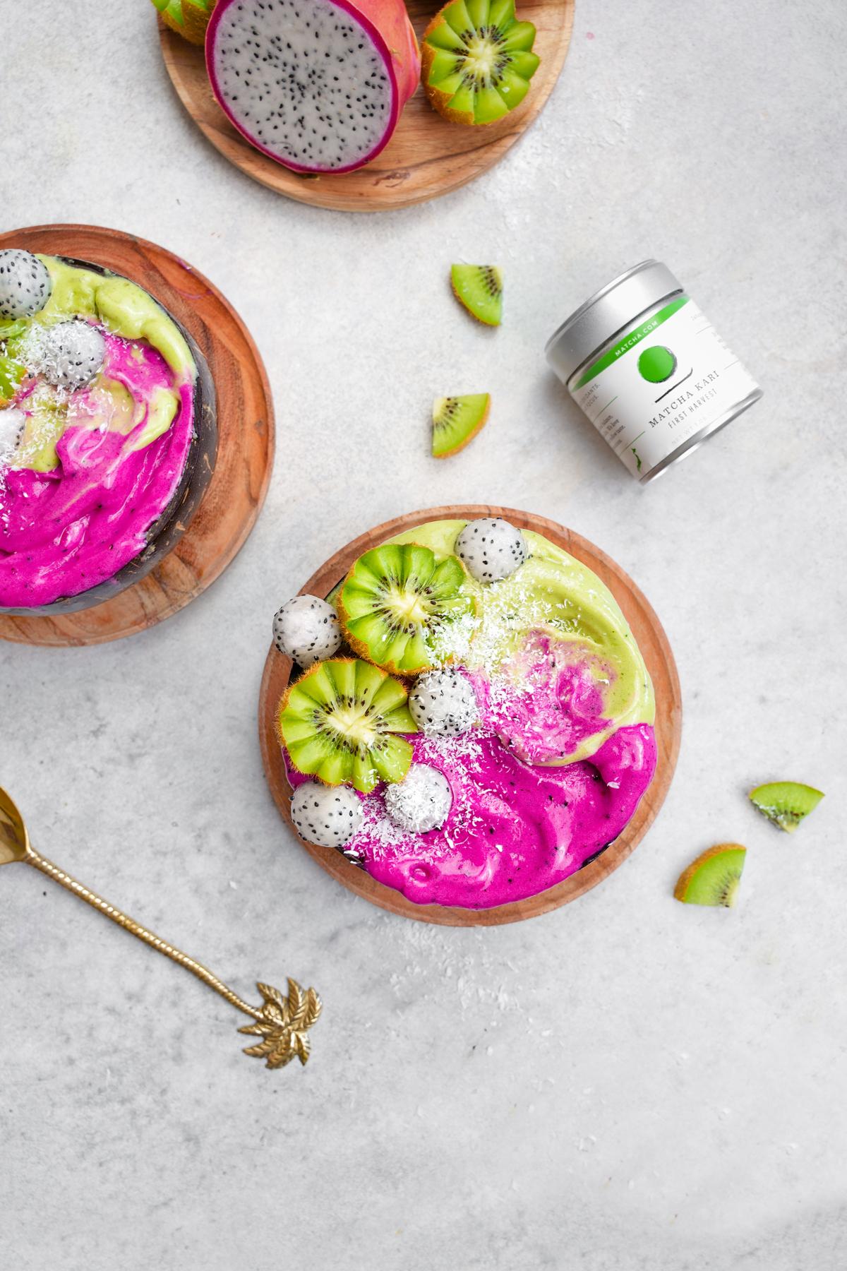 the pink and green dragoon fruit matcha smoothie bowl with the matcha.com first harvest container next to it