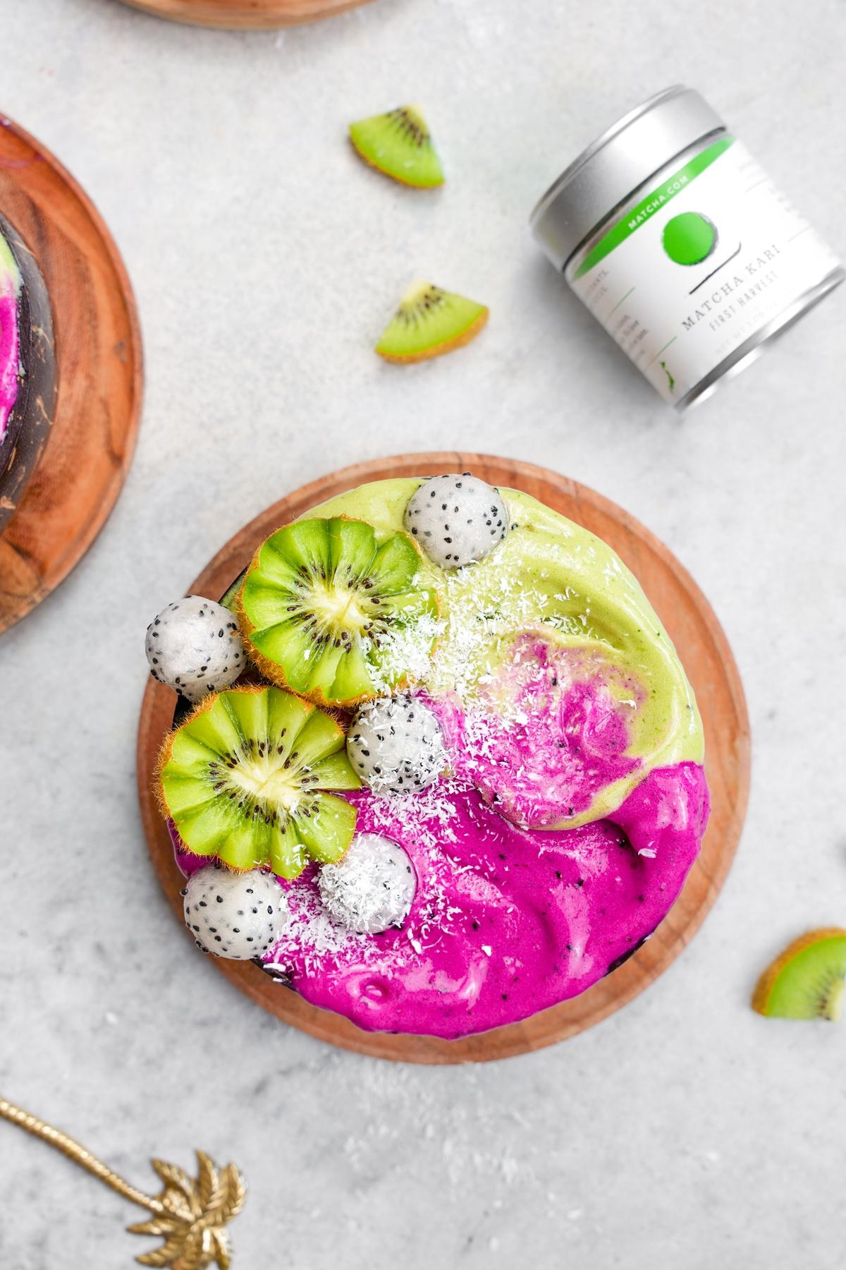 overhead shot of the matcha smoothie bowl with fresh kiwis, dragon fruit and coconut
