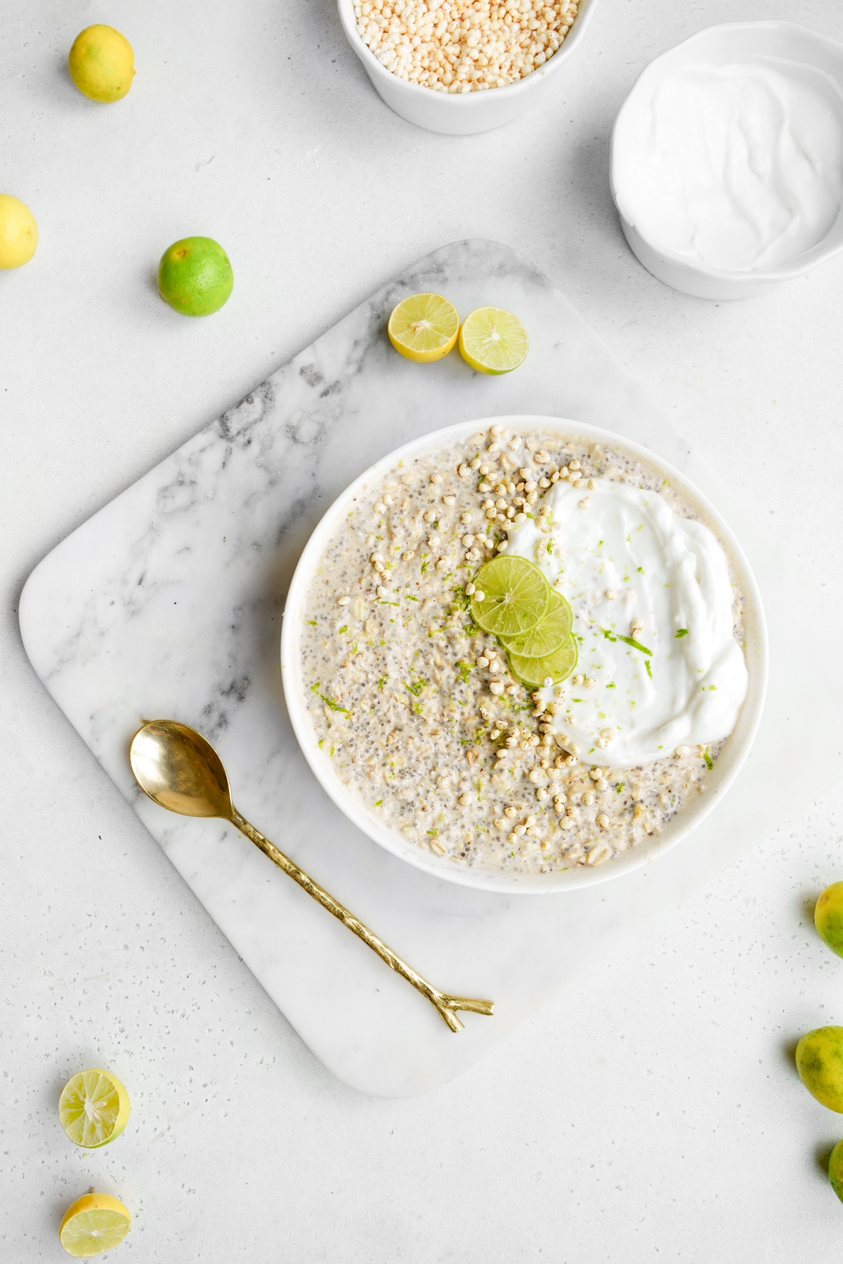 looking down at the bowl of oatmeal with a golden spoon next to it