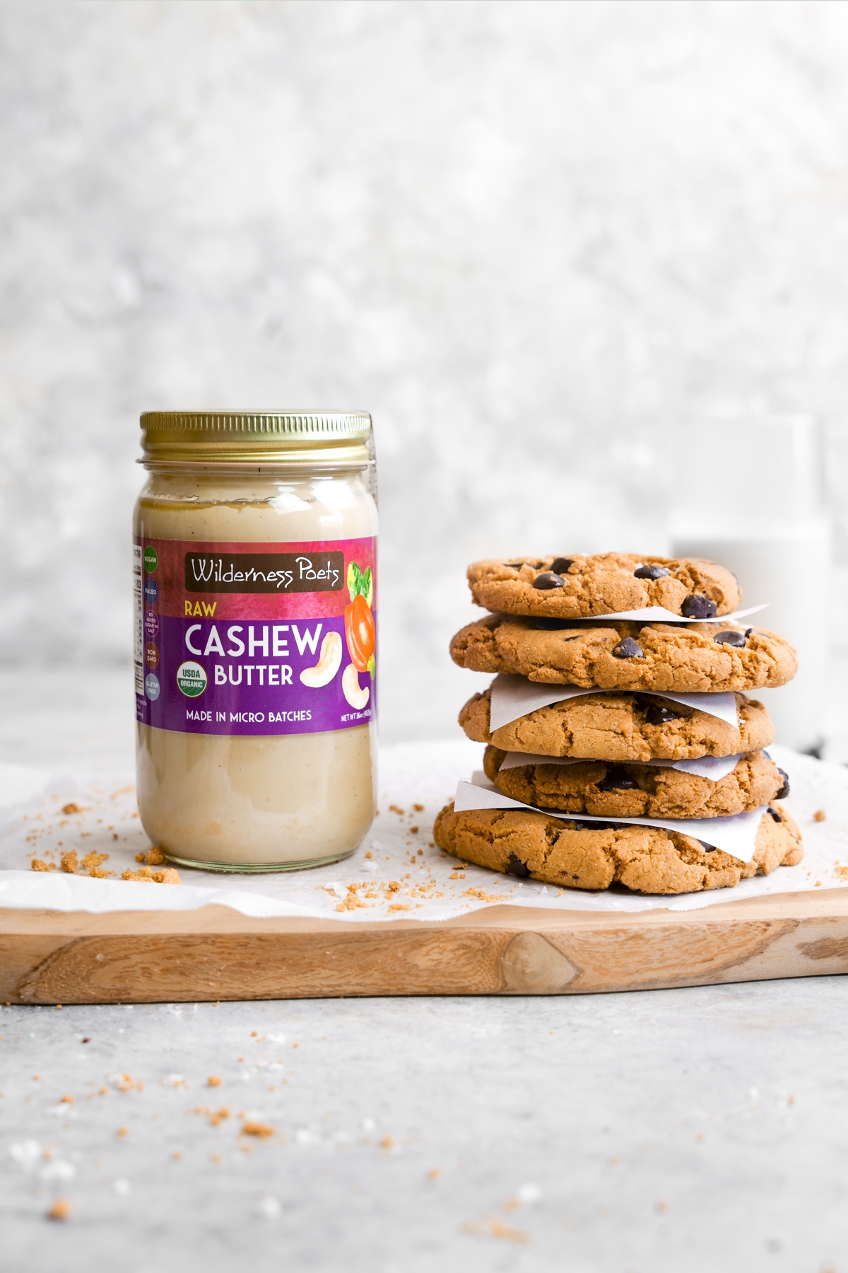 refined sugar-free chocolate chip cookies next to the raw cashew butter