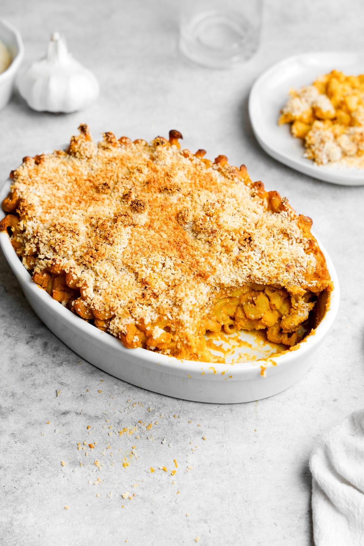 the vegan sweet potato mac and cheese with a scoop taken out to show the creamy texture