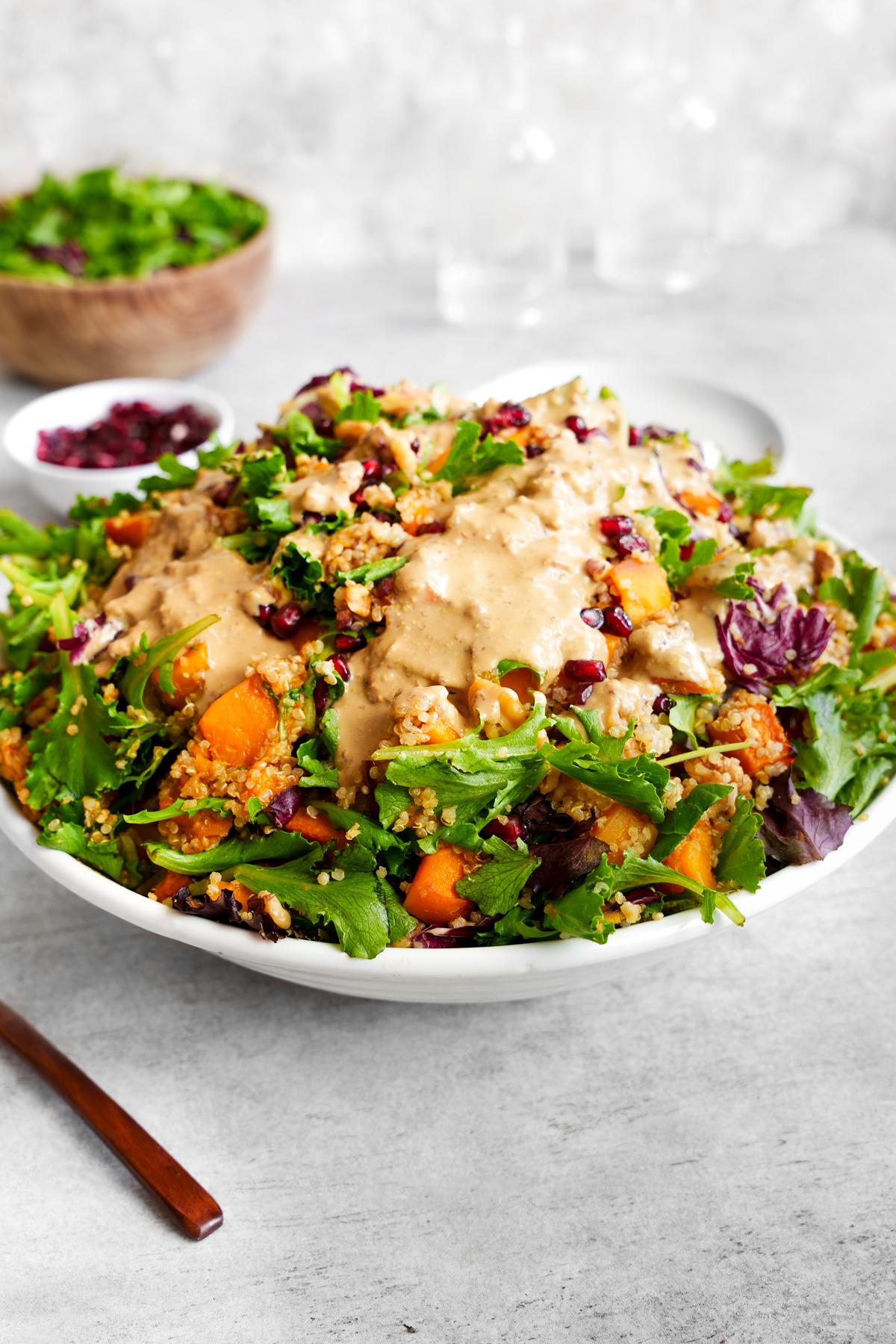 the butternut squash quinoa salad with the tahini dressing on top
