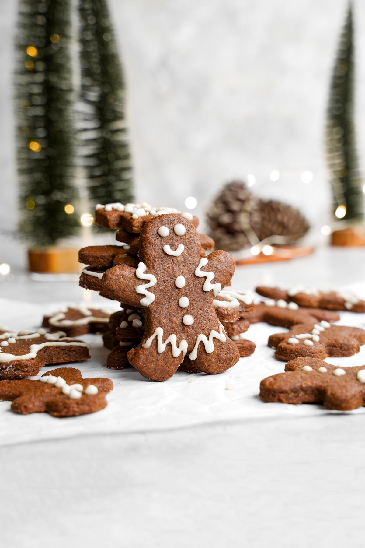 the healthy vegan gingerbread cookies stacked with one standing straight up in front