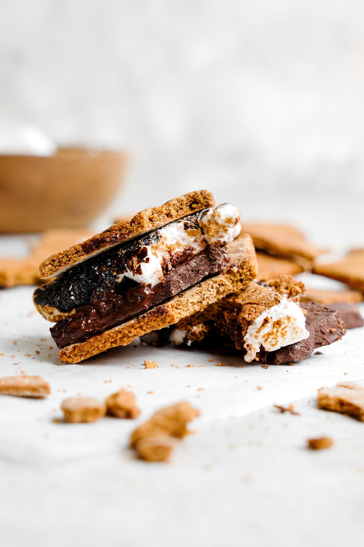 close up of the vegan graham cracker recipe used for s'mores with a bite taken out to show the perfect crisp texture