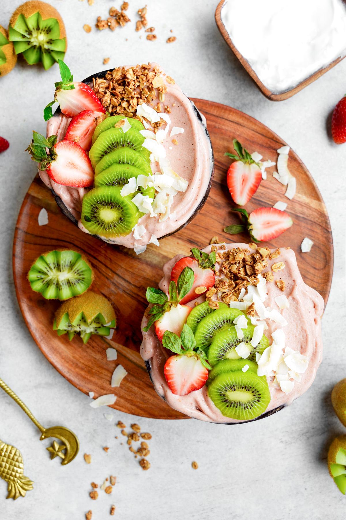 looking down at the strawberry smoothie bowl recipe with fresh kiwis and strawberries on top