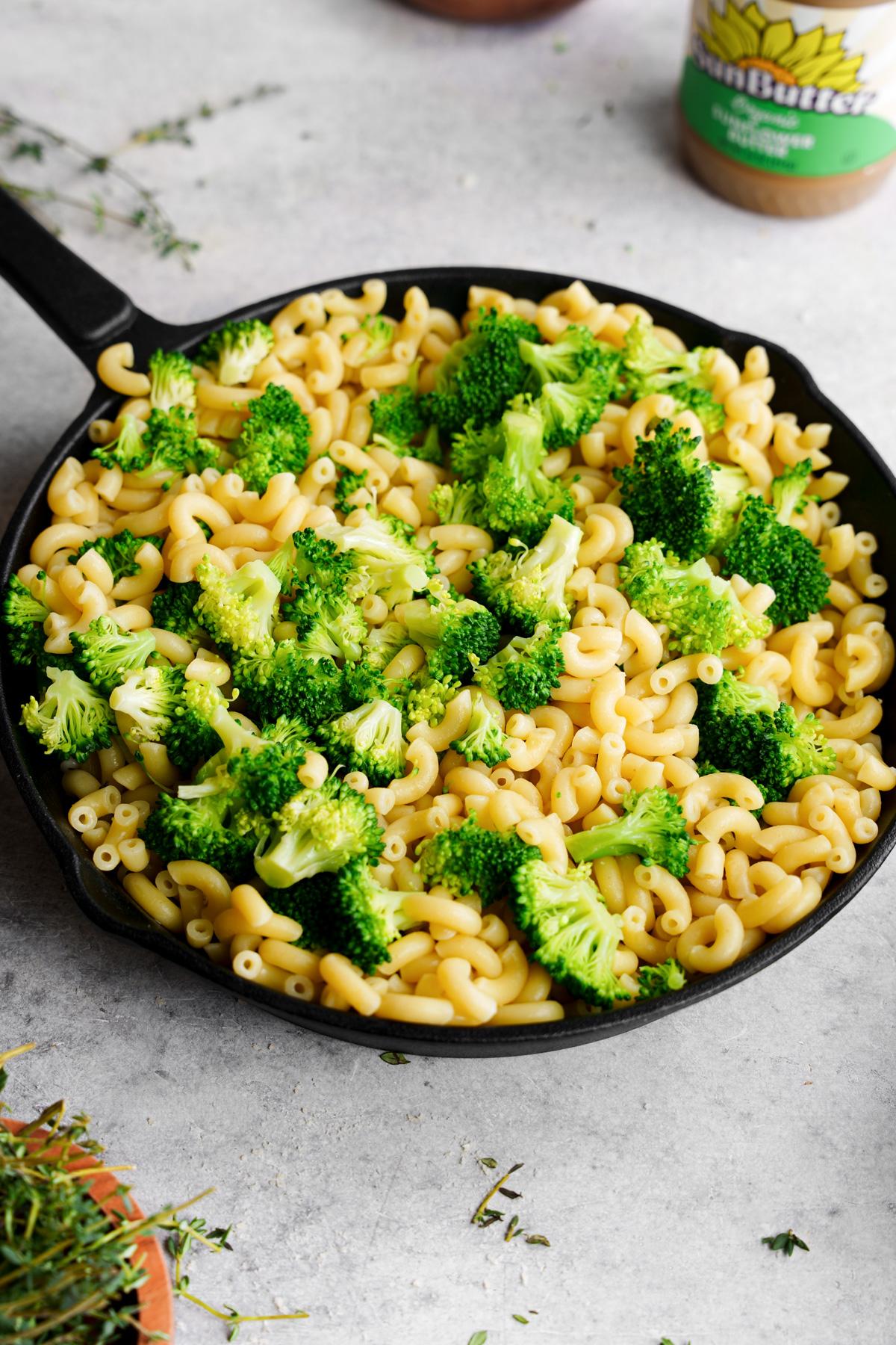 combining the broccoli and macaroni noodles