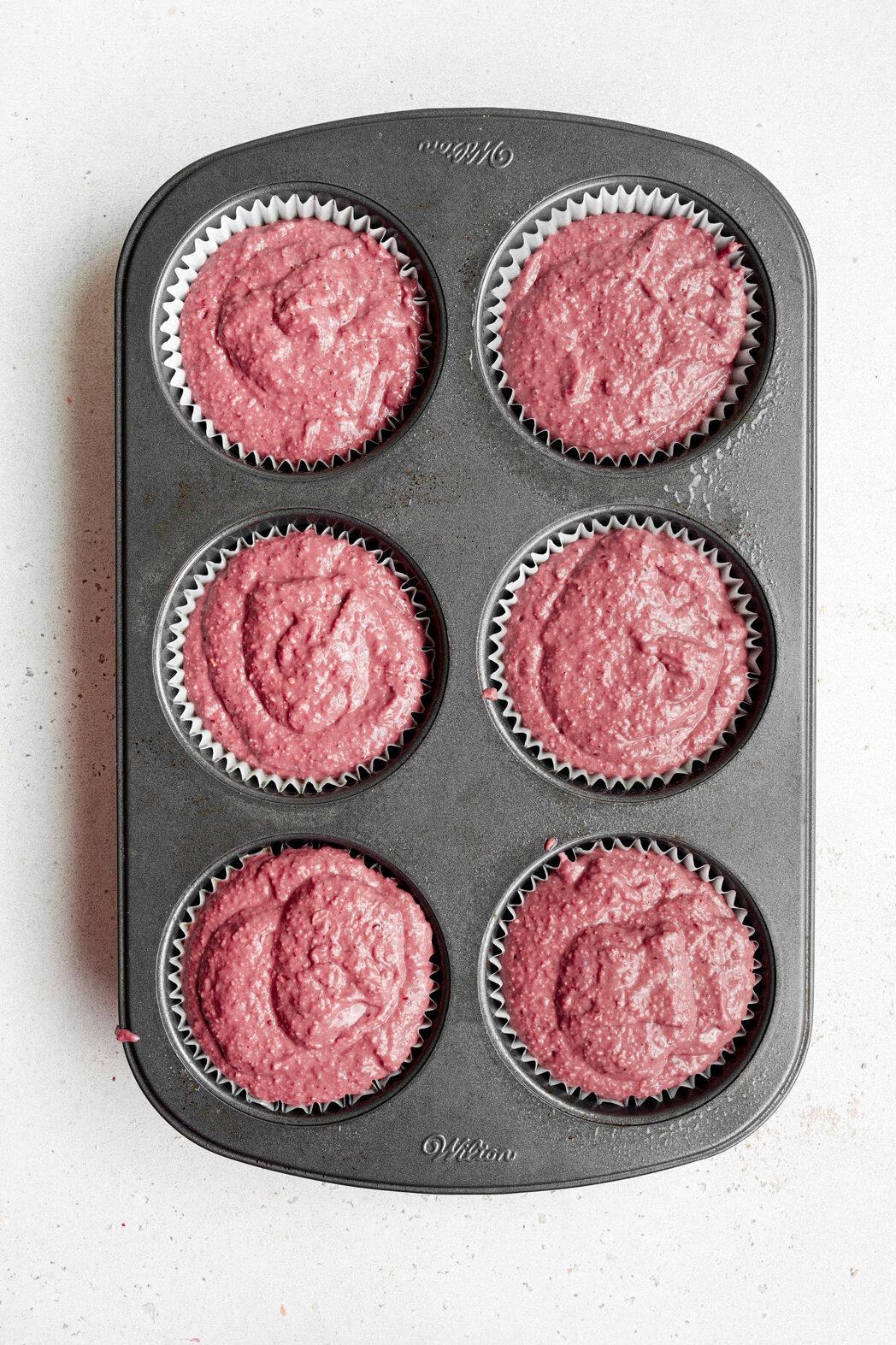 adding the batter to a muffin tin