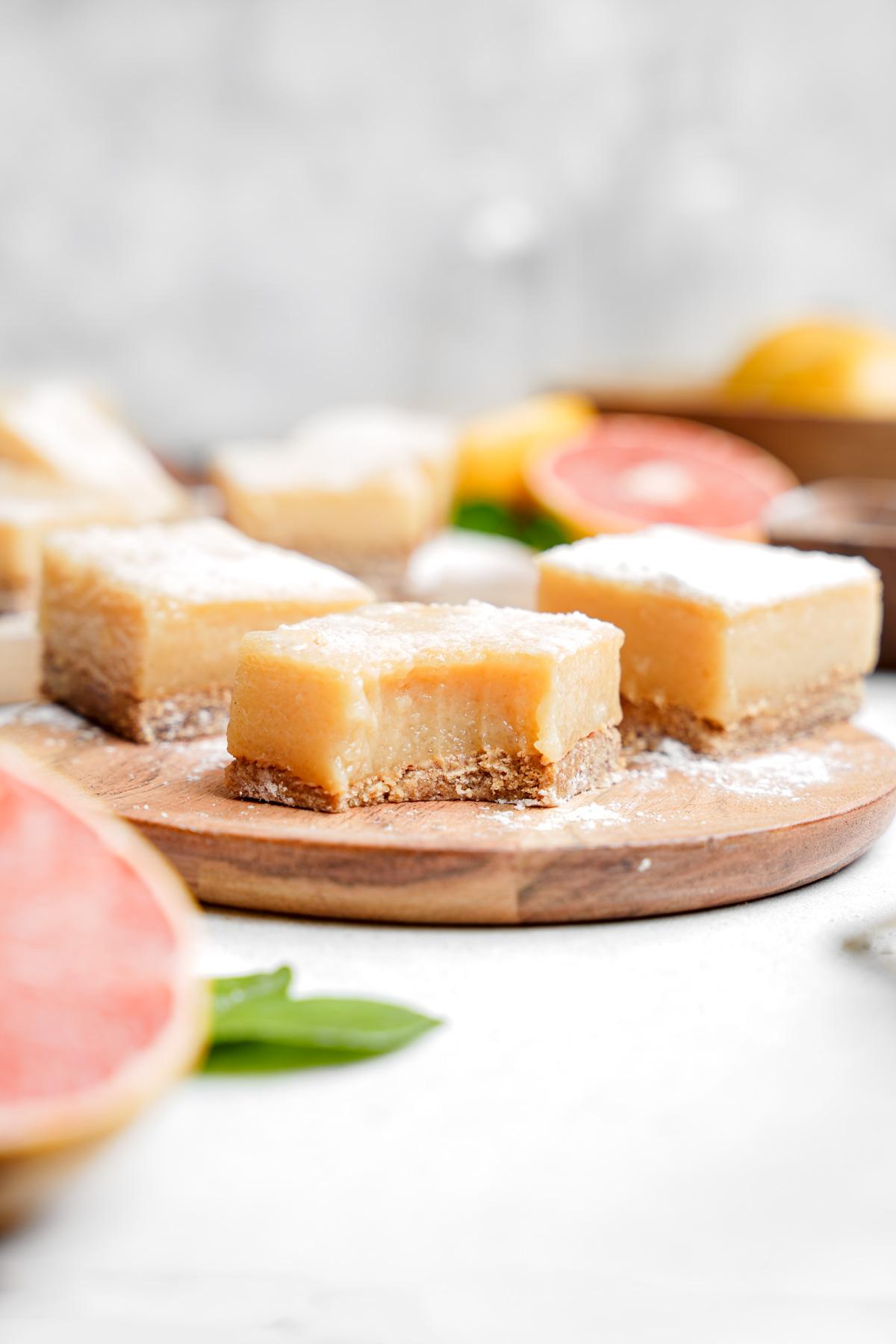 the grapefruit bars with a bite taken out of one to