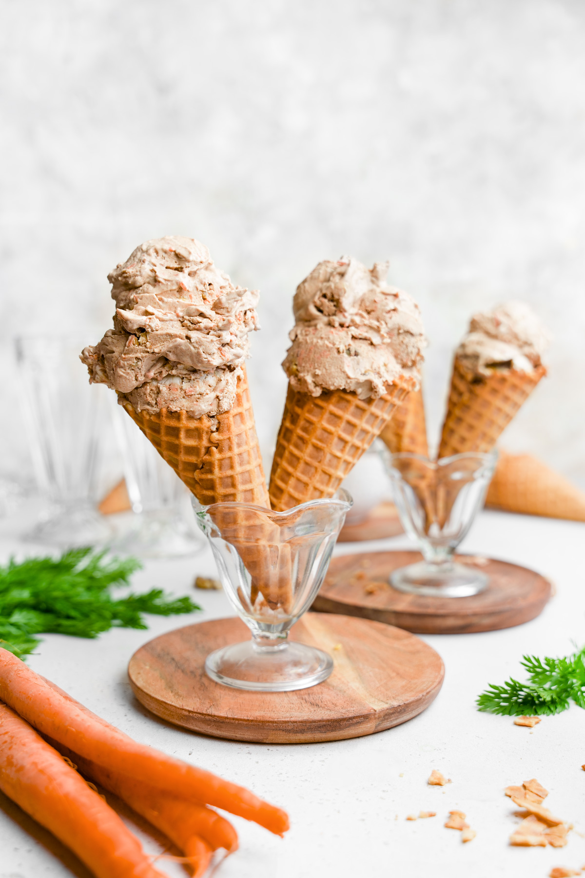 the carrot cake ice cream cones standing up in a bowl