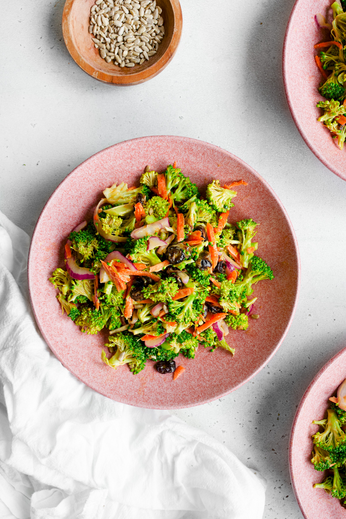 the broccoli crunch salad tossed in a serving bowl