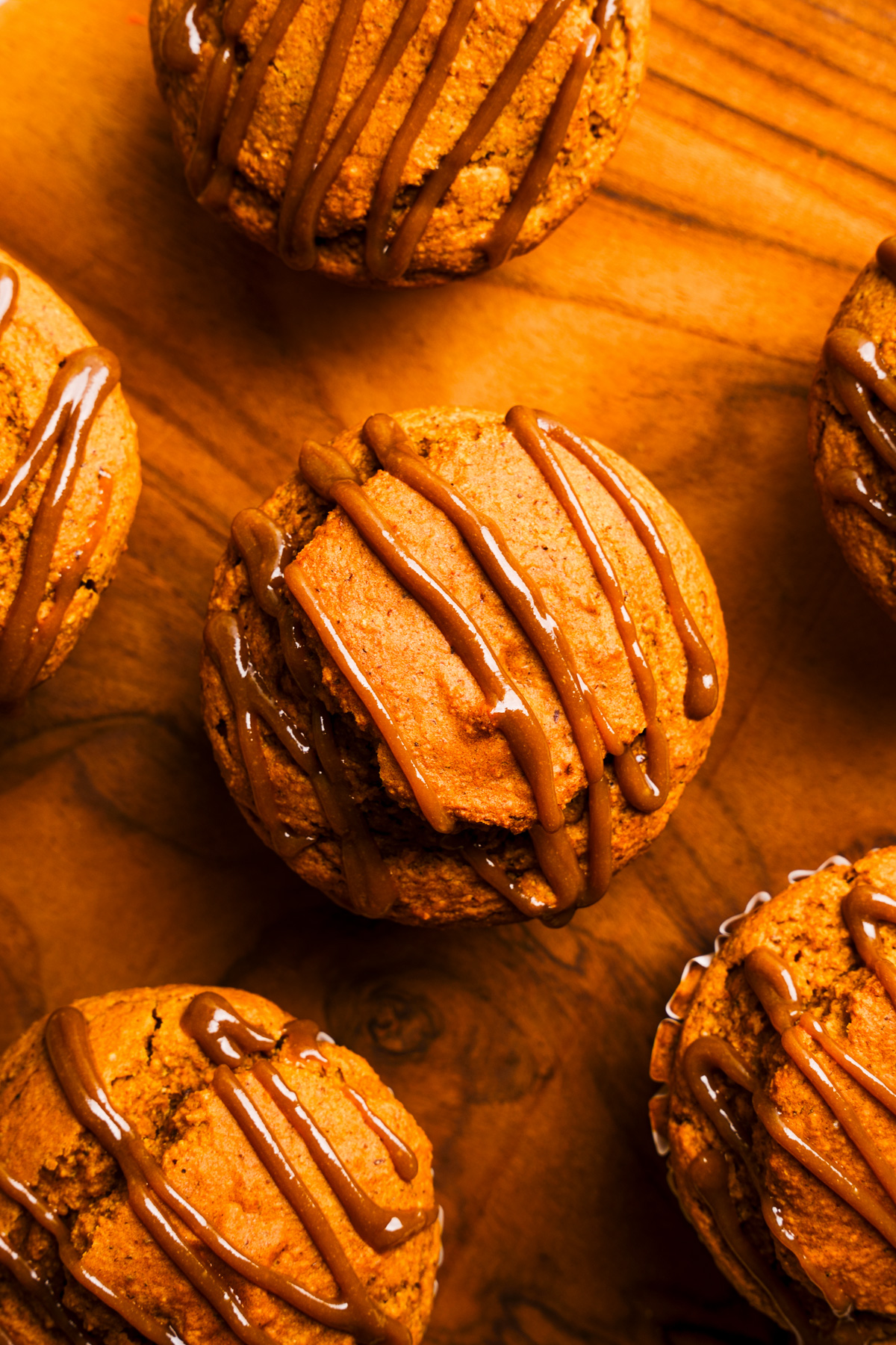 looking down at the sunflower seed muffins on a wooden plate 