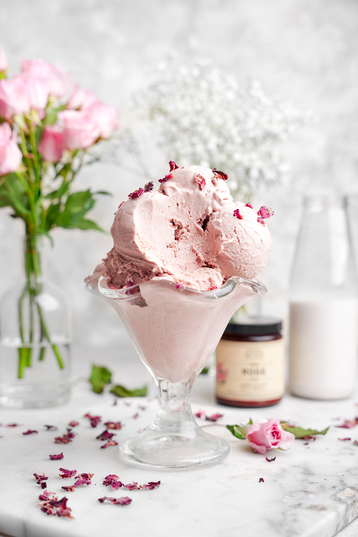 the rose ice cream with a scoop taken out of it to show the creamy texture