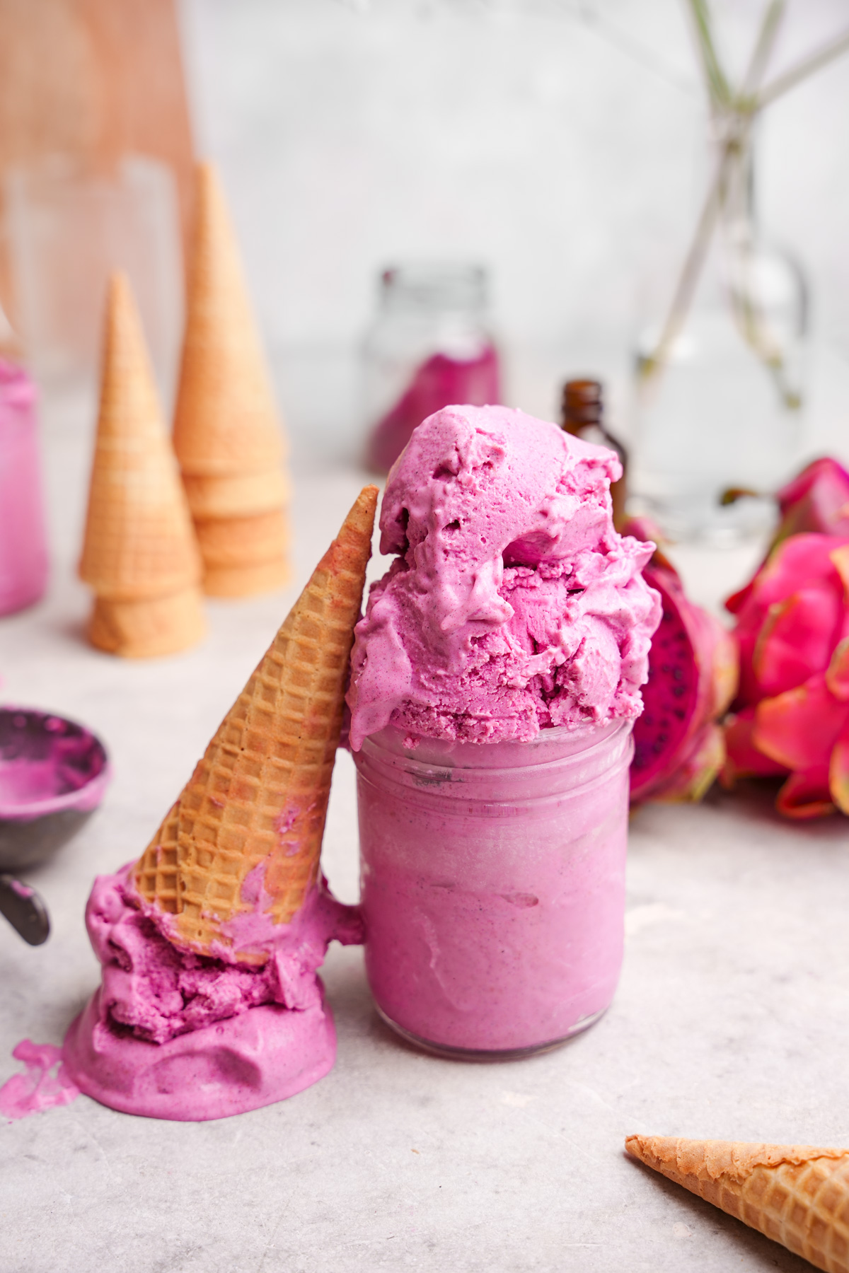 the dragon fruit ice cream in a jar with a smashed cone next to it