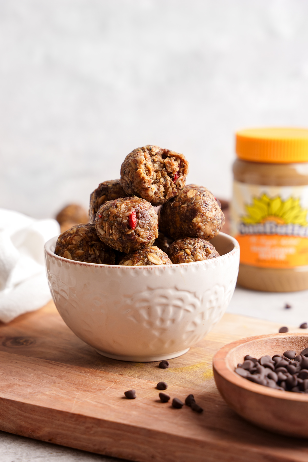 vegan energy balls in a bowl with the Sunbutter container