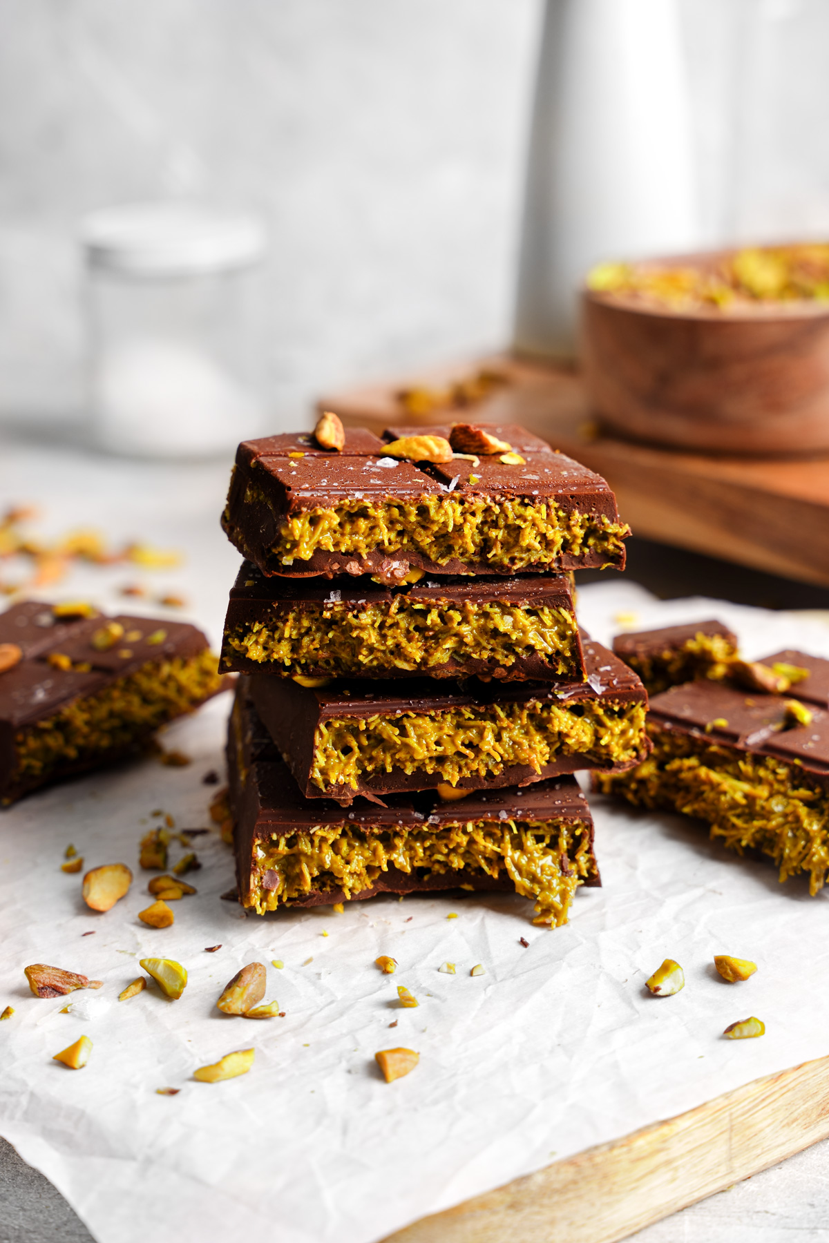 the dubai chocolate bars stacked on top of each other to show the creamy pistacho layer