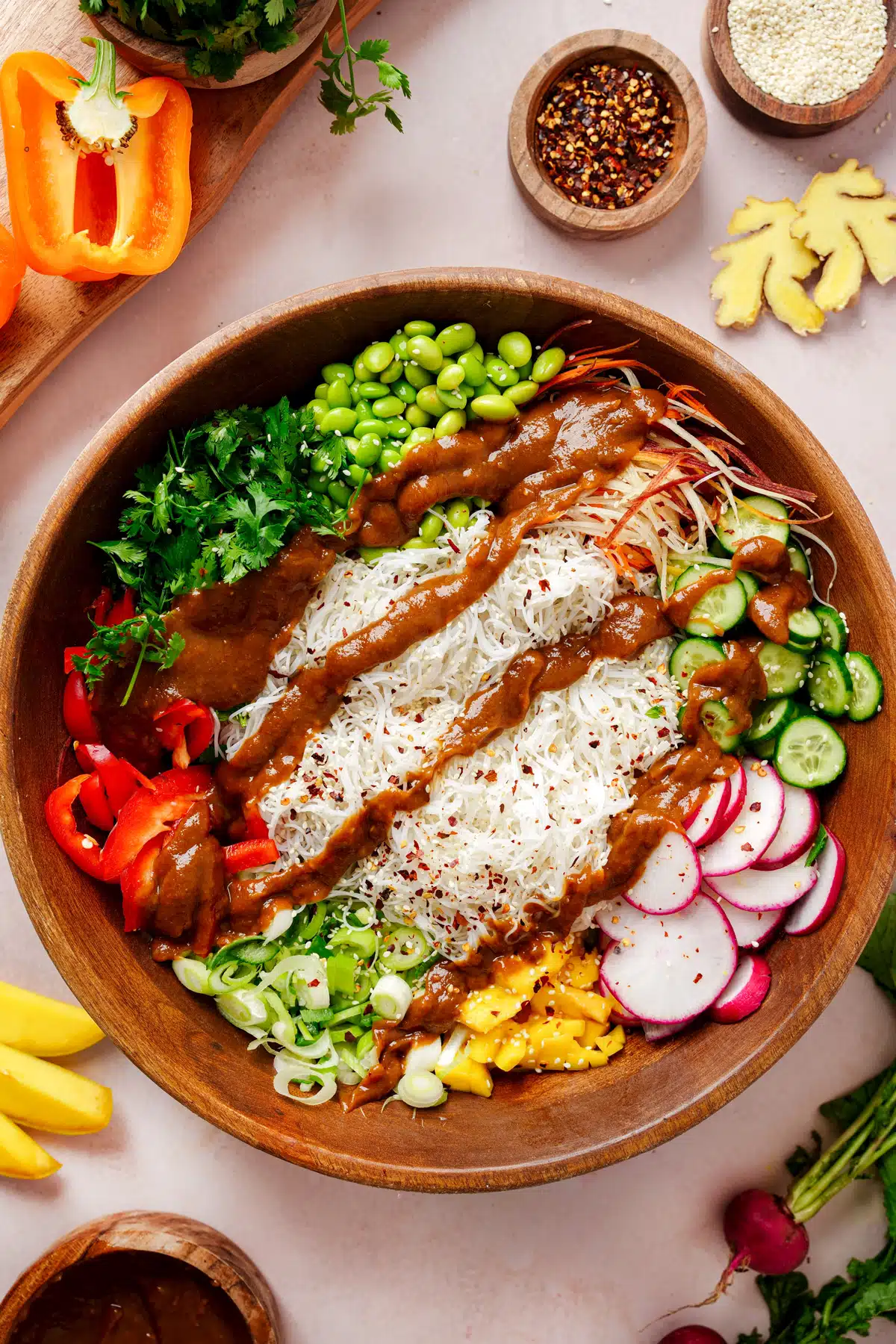 Vibrant salad of rice noodles and vegetables topped with peanut dressing.