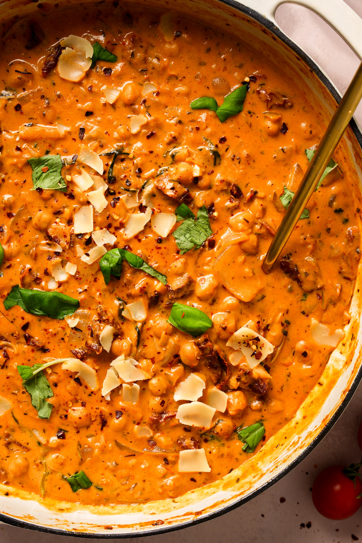 a close up of the marry me chickpeas topped with the fresh herbs and spices