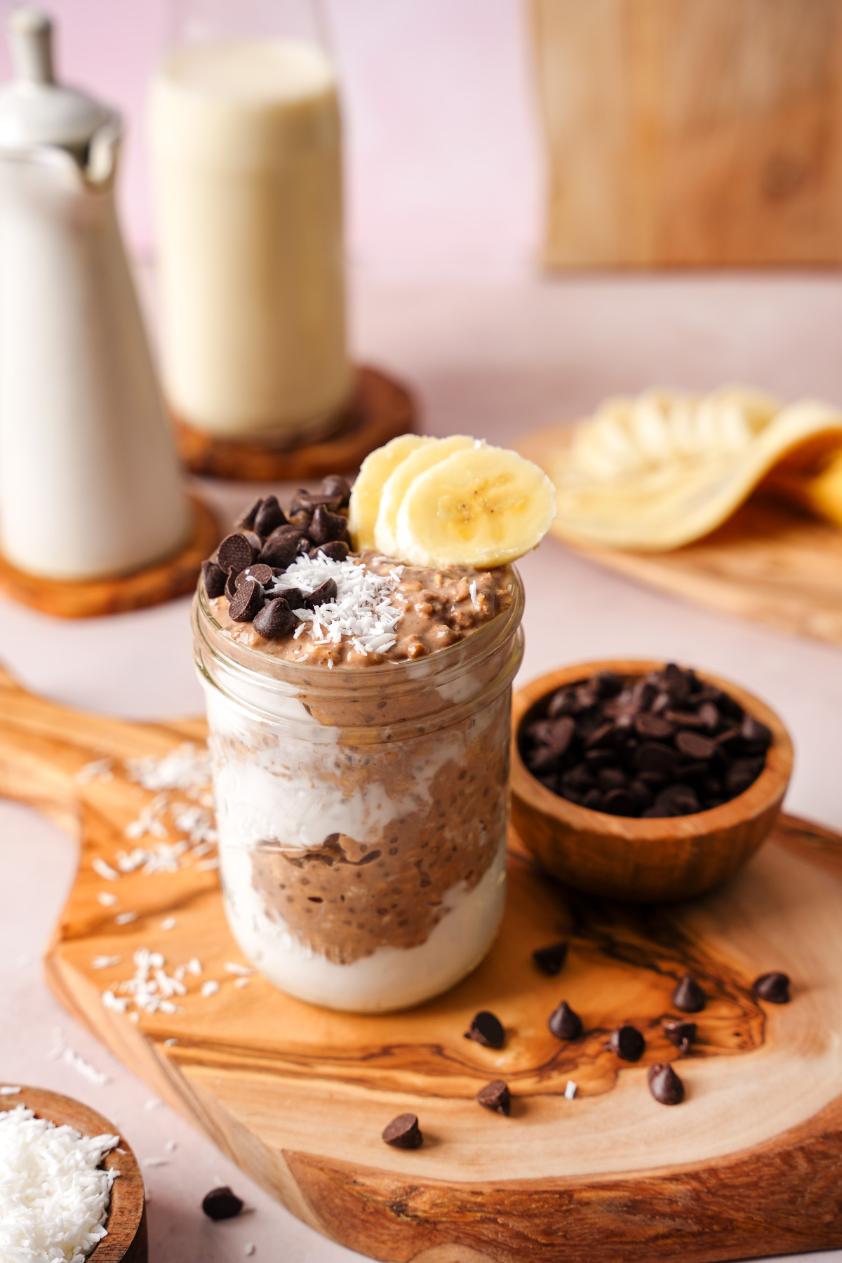 the chocolate overnight oats in a mason jar topped with chocolate chips