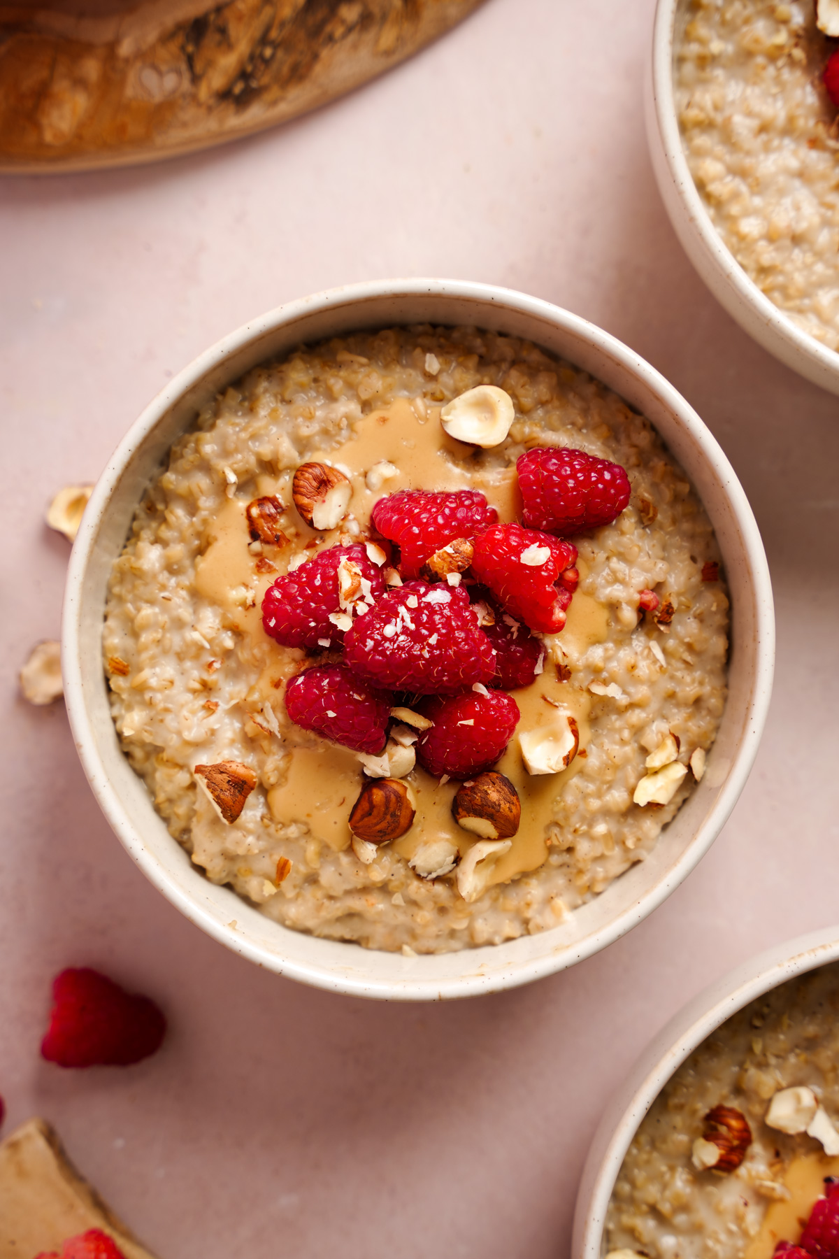 a close up of the hazelnut steel cut oats topped with fresh fruits