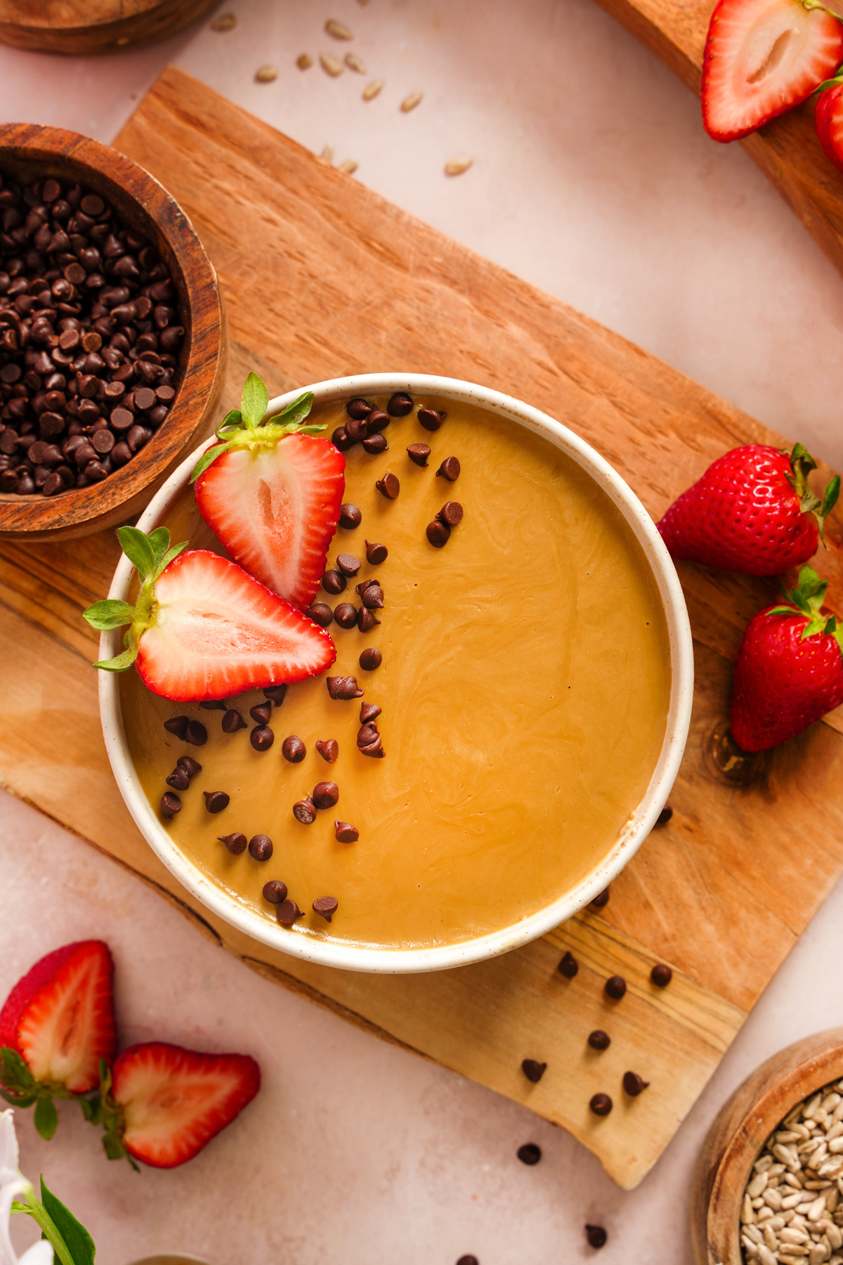 looking down at the blended oats topped with sunbutter chocolate chips and fresh strawberries
