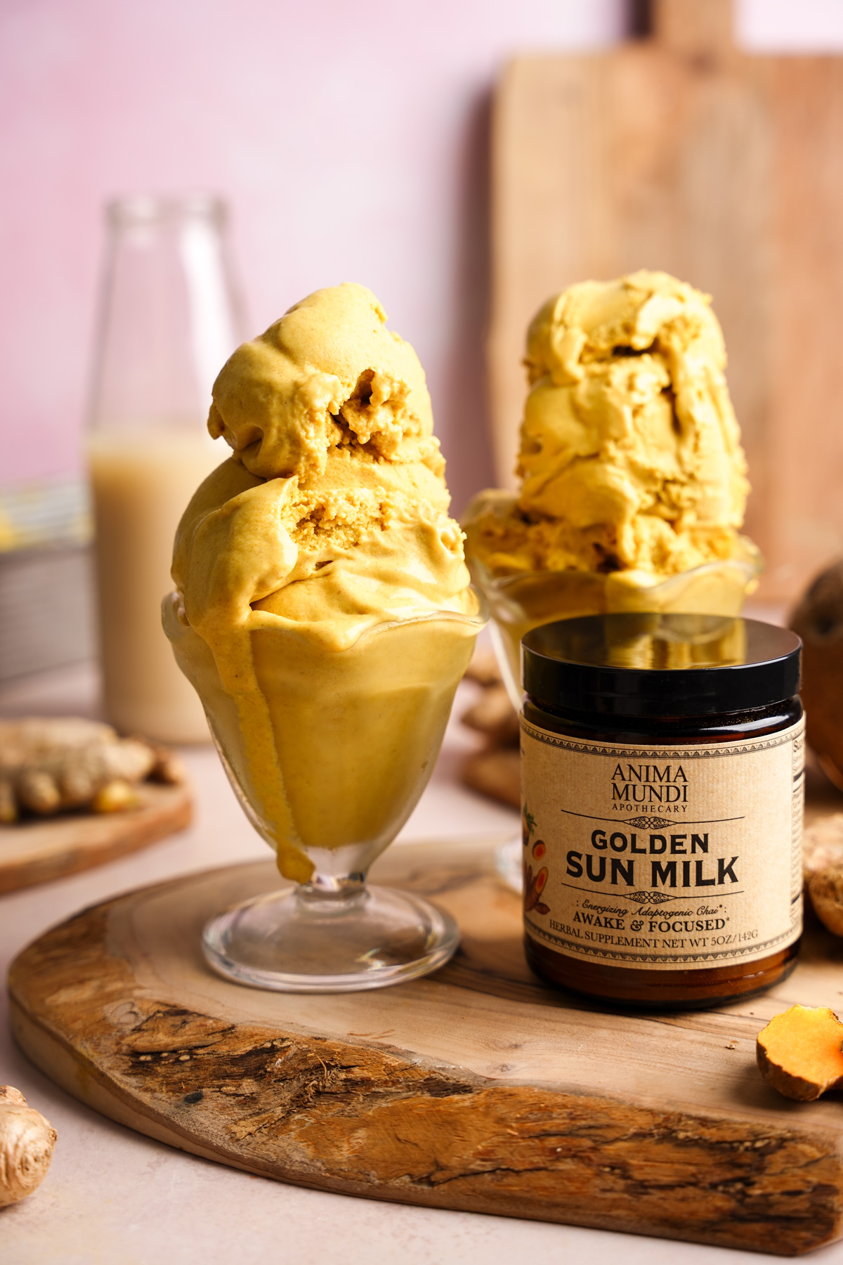 the golden milk ice cream in an ice cream cup next to the anima mundi golden sun milk