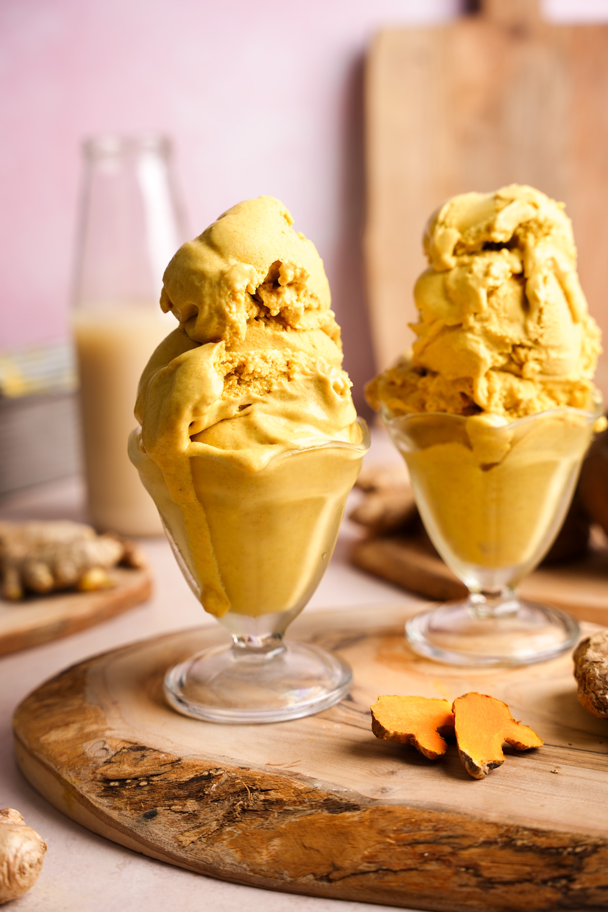 two cups of golden milk ice cream melting