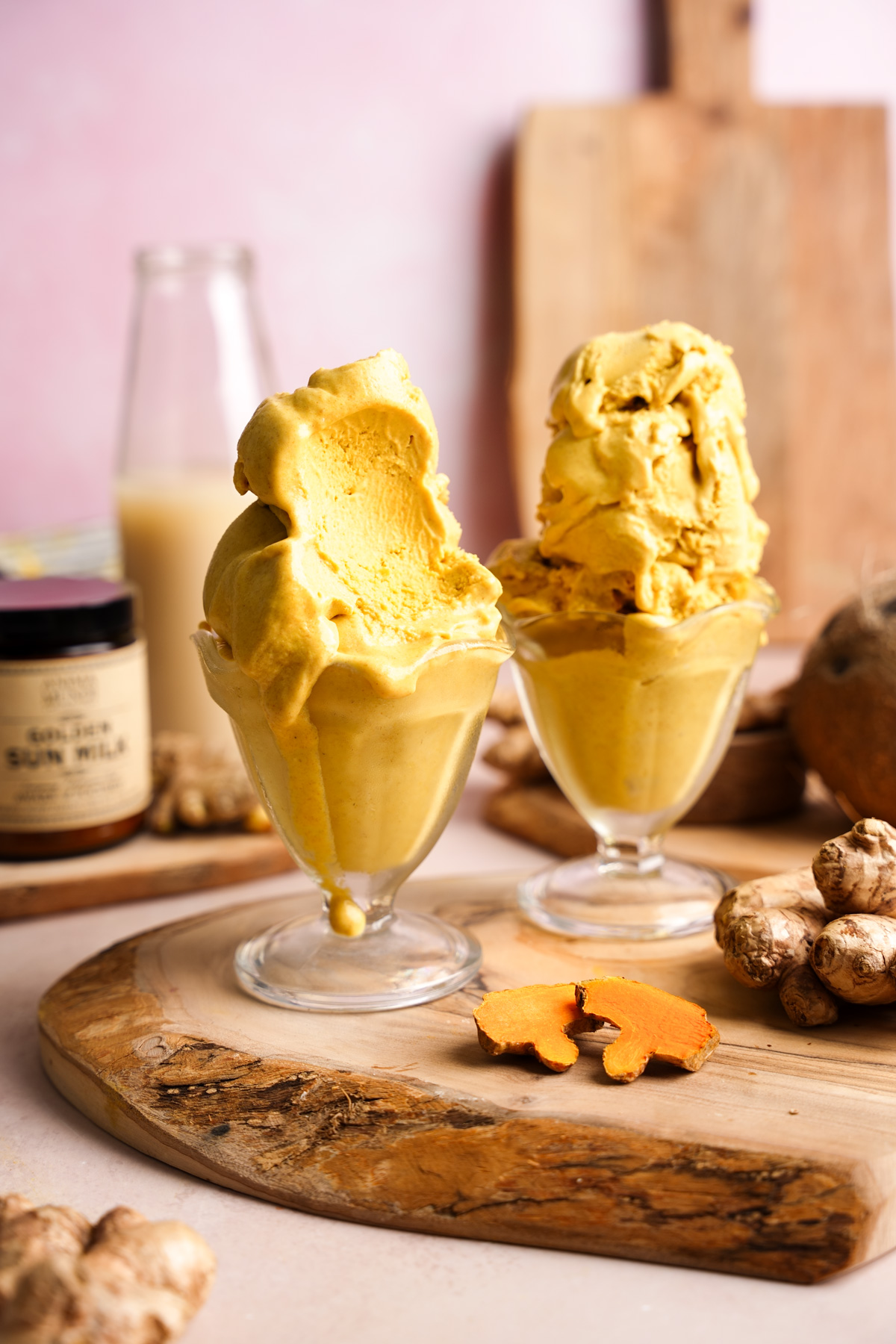 the golden milk ice cream with a scoop taken out of it to show the smooth and creamy texture