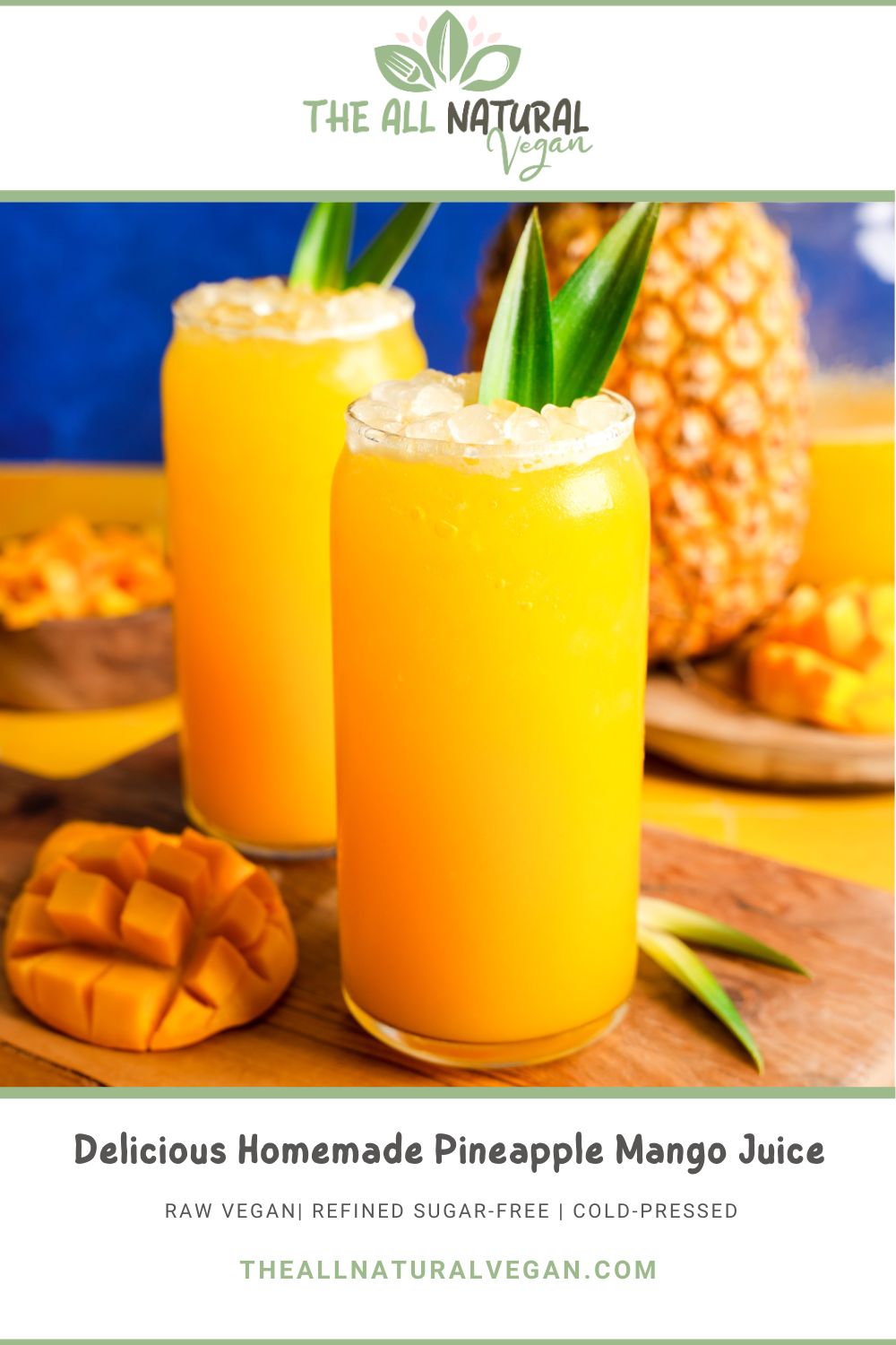Bright and refreshing homemade pineapple mango juice served in tall glasses with crushed ice and pineapple leaf garnishes, surrounded by fresh mango cubes and a whole pineapple, labeled as raw vegan, refined sugar-free, and cold-pressed.